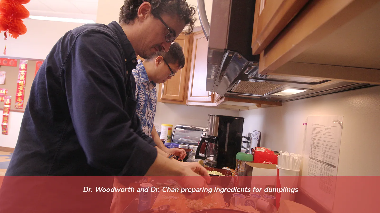 Dr. Woodworth and Dr. Chan preparing ingredients for dumplings